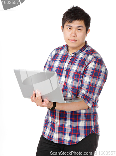 Image of Young asian man holding laptop computer
