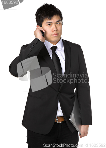 Image of young business man with mobile phone
