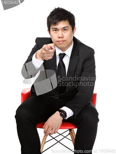 Image of business man sit and point to you