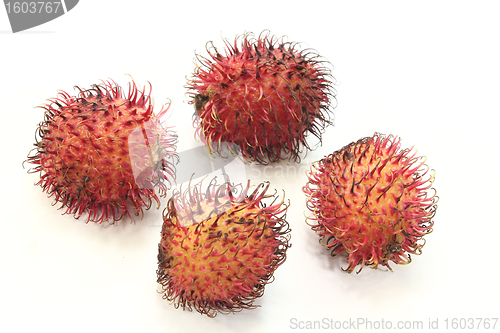Image of four red rambutan