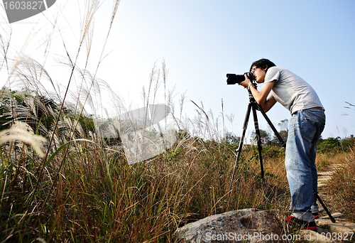 Image of photographer taking photo in wild