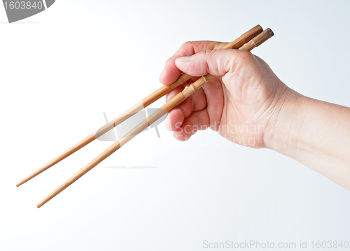 Image of hand using chopsticks