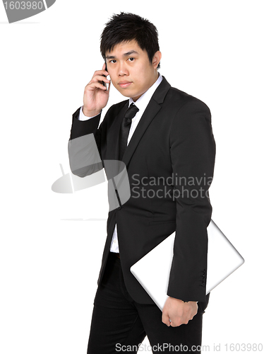 Image of young business man with mobile phone