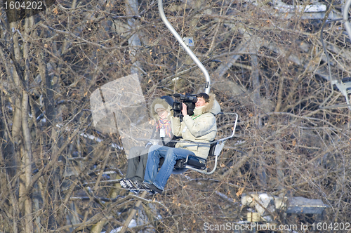 Image of director with assistant in ski-lift support