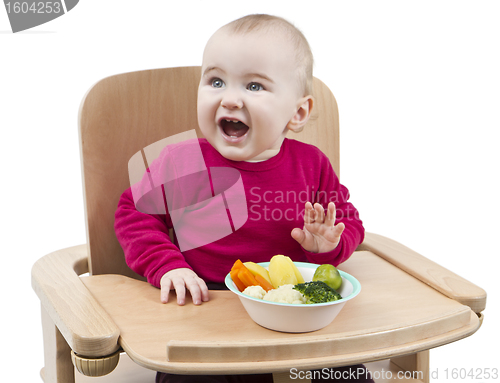 Image of young child eating in high chair