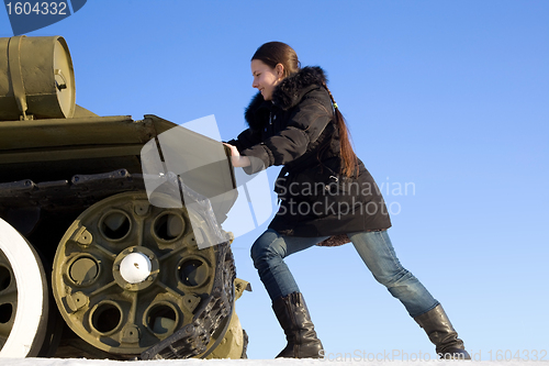 Image of The girl pushes the tank. Joke