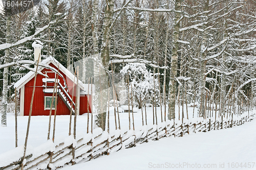 Image of Little red house covered by snow