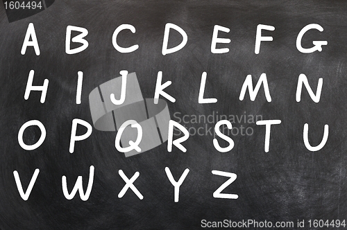 Image of English alphabet handwritten with white chalk on a blackboard