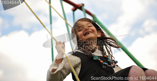 Image of swinging girl