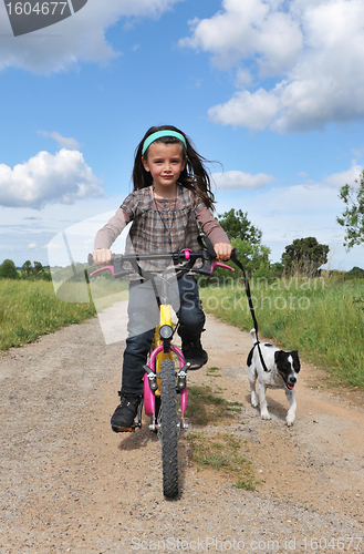 Image of girl withe dog on bicycle