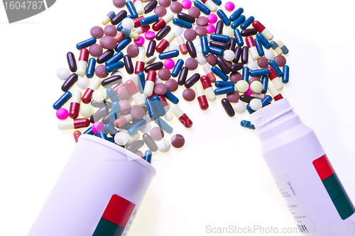 Image of pills spilling out of container 