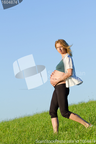 Image of pregnant woman on meadow