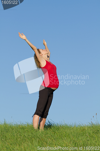 Image of pregnant woman on meadow