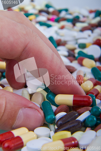 Image of hand grabbing pills