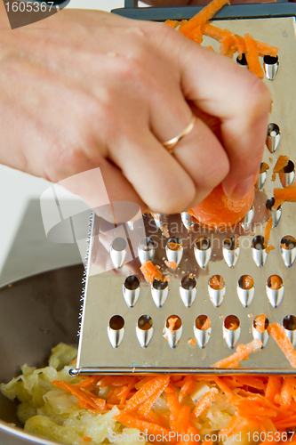 Image of chef grating carrot