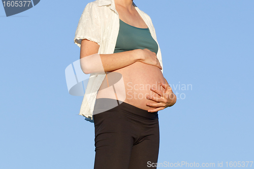 Image of pregnant woman on meadow