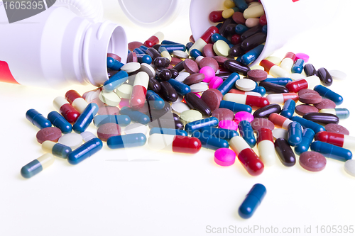 Image of pills spilling out of container 