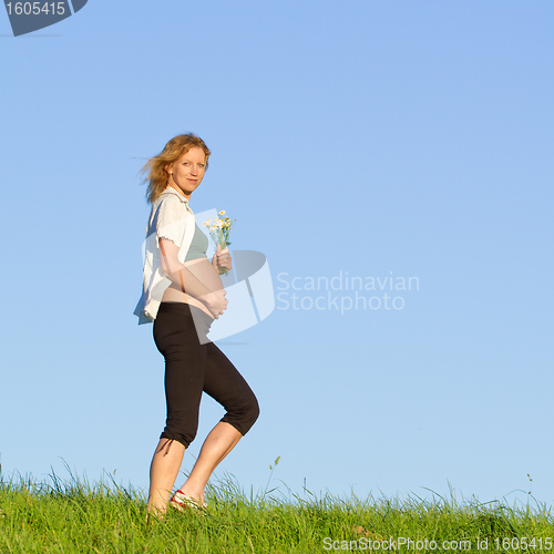 Image of pregnant woman on meadow