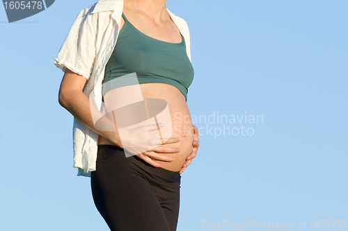 Image of pregnant woman on meadow