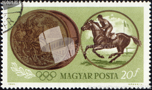 Image of Sportsman riding horse and Olympic medal on post stamp