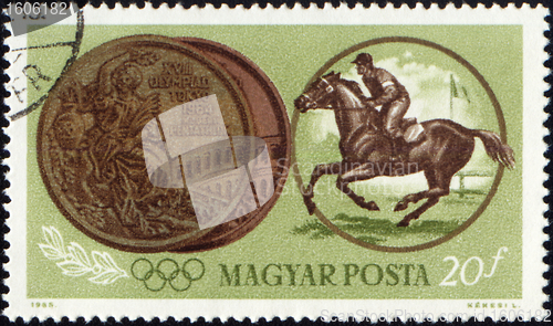 Image of Sportsman riding horse and Olympic medal on post stamp