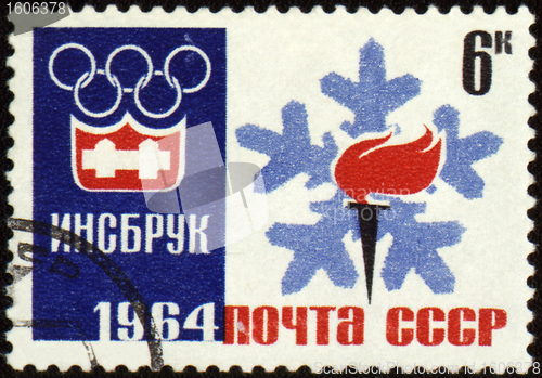 Image of Olympic torch and emblem on post stamp