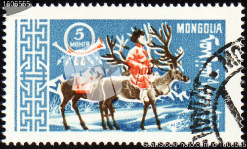 Image of Man with reindeer in winter time on post stamp