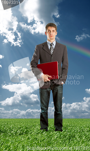 Image of Full length portrait of businessman with laptop outdoor