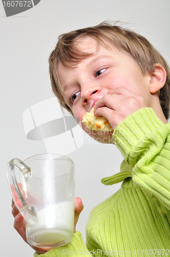 Image of child eating cake and drinking milk