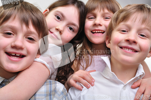 Image of happy group of children hugging together