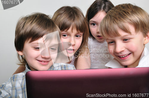 Image of group of children friends playing computer games