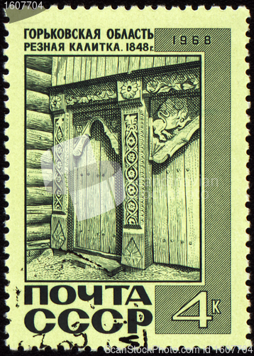 Image of Old wooden wicket with carving on post stamp
