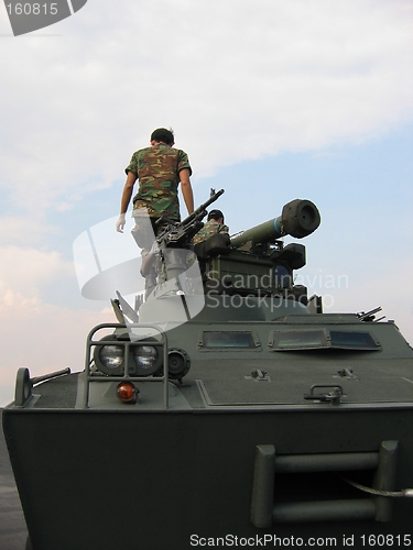 Image of Military - soldiers on tank with machine gun