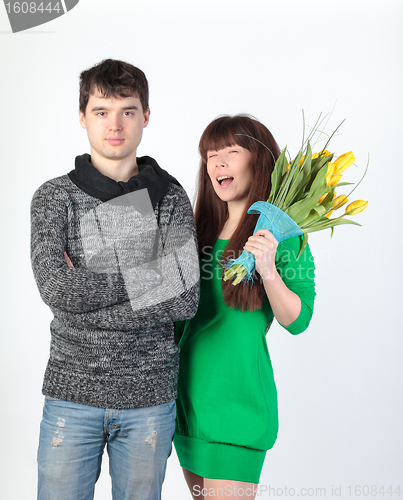 Image of happy young couple with bouquet flowers