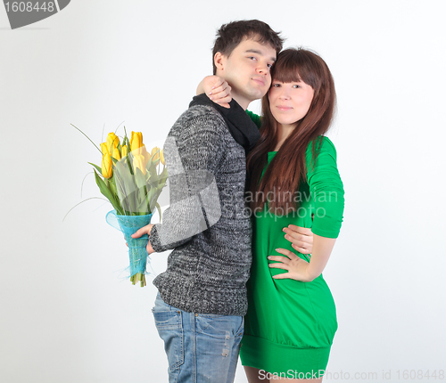 Image of happy young couple with bouquet flowers