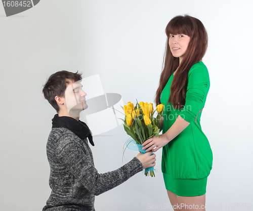 Image of happy young couple with bouquet flowers