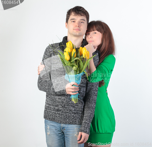 Image of happy young couple with bouquet flowers