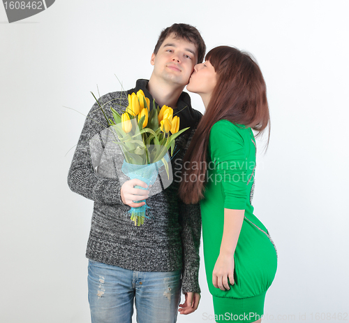 Image of happy young couple with bouquet flowers