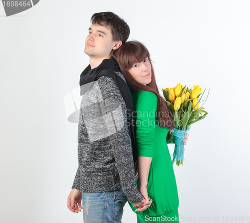 Image of happy young couple with bouquet flowers