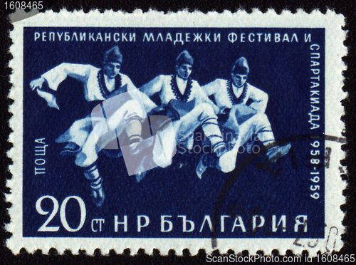 Image of Three dancing men in Bulgarian national costumes on post stamp