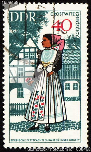 Image of Young woman in national costume on post stamp