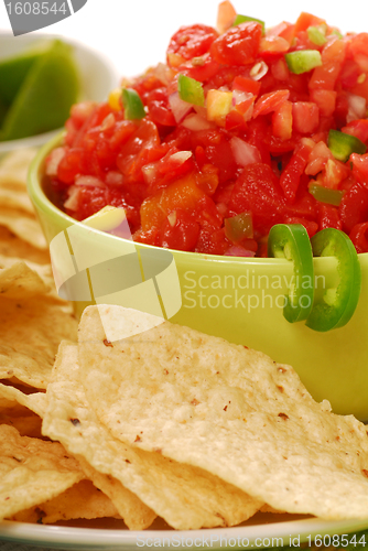 Image of Tortilla chips with salsa and lime