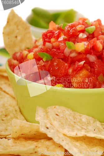 Image of Tortilla chips with salsa and lime