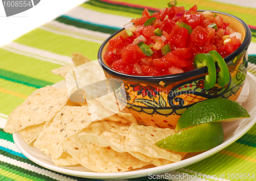 Image of Tortilla chips with salsa and lime