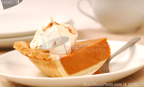Image of Slice of pumpkin pie with whipped cream