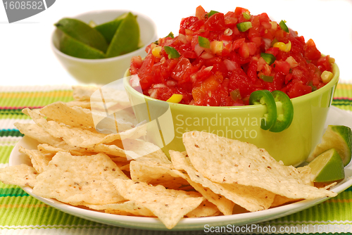 Image of Tortilla chips with salsa and lime