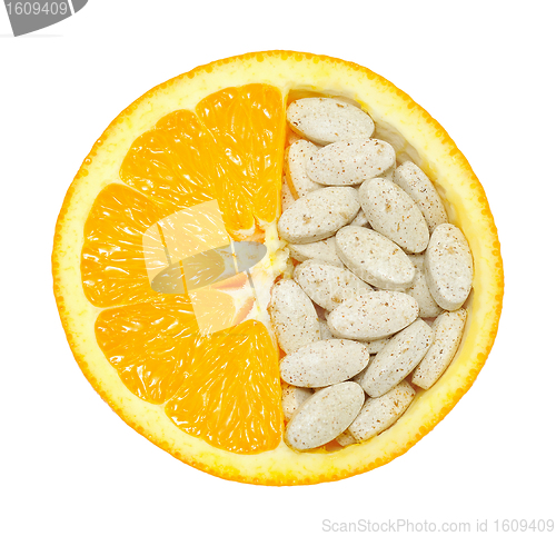 Image of Close up of orange and pills isolated