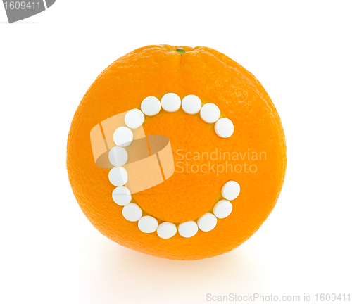 Image of Orange with vitamin c pills over white background