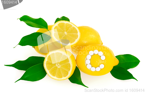 Image of Lemons with vitamin c pills over white background 