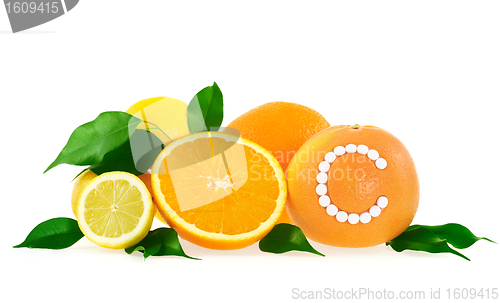 Image of Orange, lemon, grapefruit with vitamin c pills over white background 